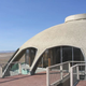 Illustration for article titled A House Shaped Like a Flying Saucer, Perched Atop a Volcano